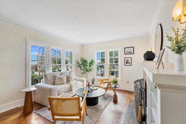 a living room with furniture and floor to ceiling windows