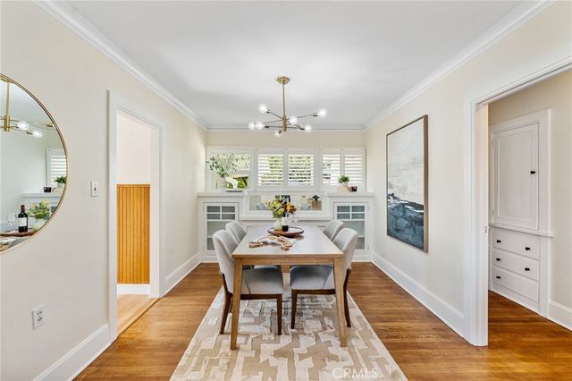 a view of a a dining room with furniture window and wooden floor