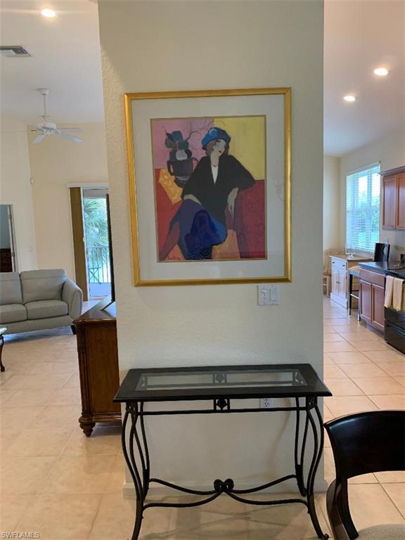 6821 Ascot Drive, Unit 202 Naples, FL 34113 - Photo 11 of 35 a view of workspace with furniture and paintings on wall