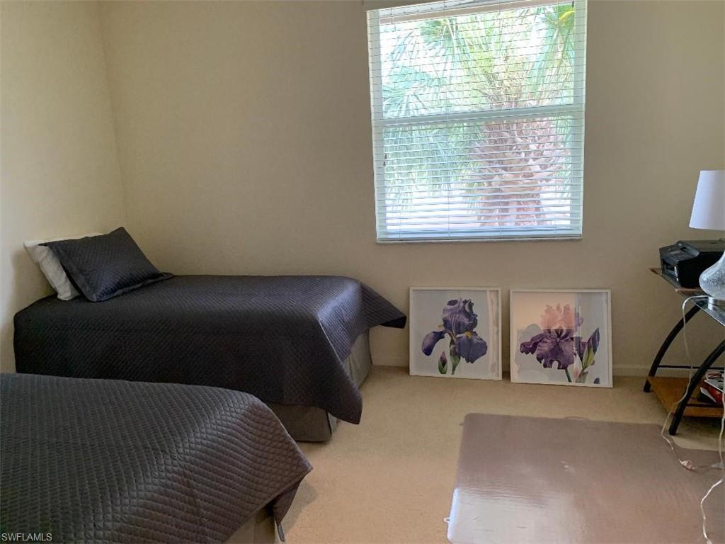 6821 Ascot Drive, Unit 202 Naples, FL 34113 - Photo 14 of 35 a bedroom with a bed and a window