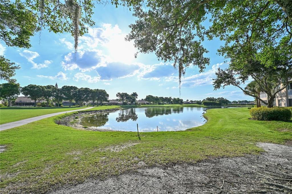6821 Ascot Drive, Unit 202 Naples, FL 34113 - Photo 19 of 35 a view of a swimming pool with a yard