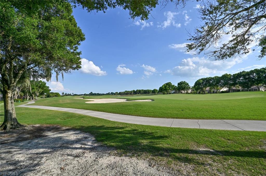 6821 Ascot Drive, Unit 202 Naples, FL 34113 - Photo 20 of 35 a view of a golf course with a lake view