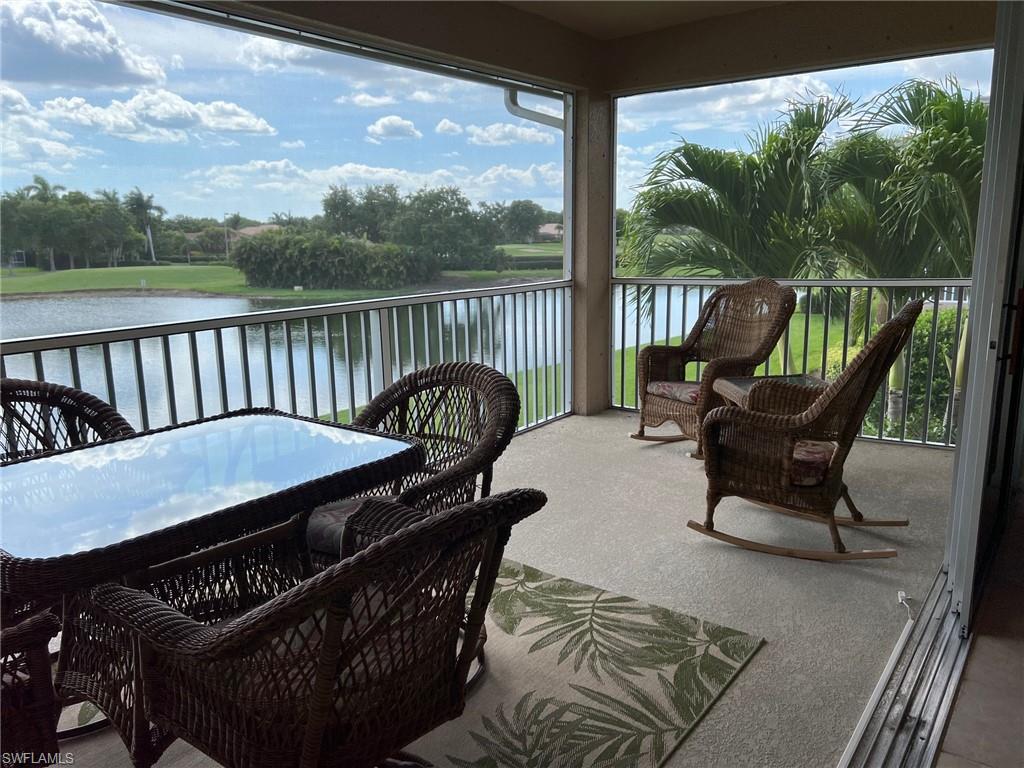6821 Ascot Drive, Unit 202 Naples, FL 34113 - Photo 2 of 35 a roof deck with a table and chairs