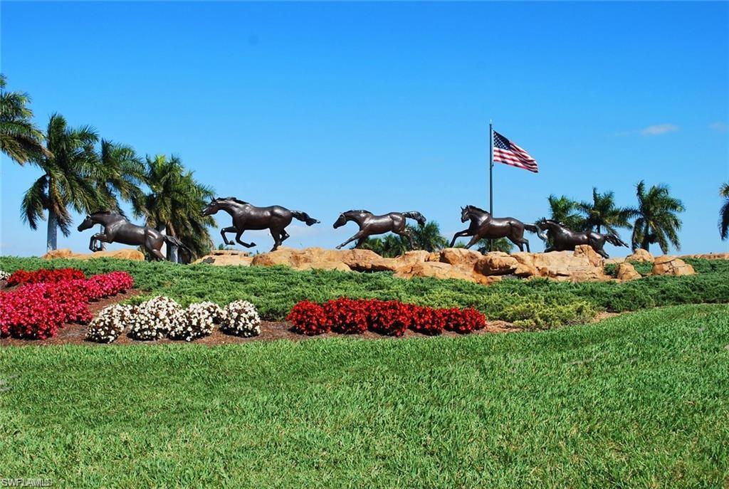6821 Ascot Drive, Unit 202 Naples, FL 34113 - Photo 32 of 35 a view of a garden with flowers and palm tree