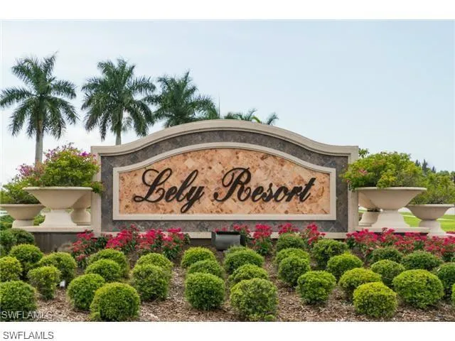 a sign that is sitting in front of flowers