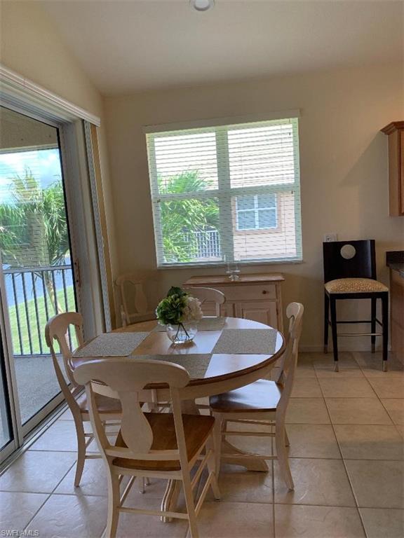 6821 Ascot Drive, Unit 202 Naples, FL 34113 - Photo 8 of 35 a view of a dining room with furniture and window