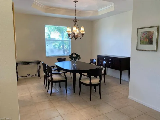 a dining room with furniture and chandelier