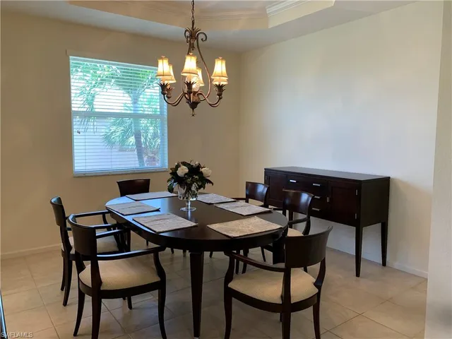 a view of a dining room with a table and chairs