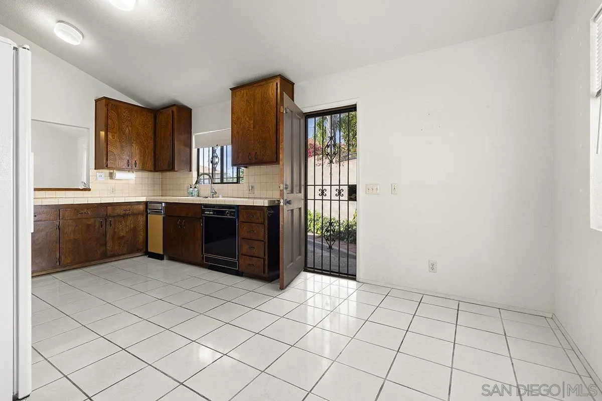 3344 Goldfinch Street San Diego, CA 92103 - Photo 14 of 41 a view of kitchen with granite countertop cabinets sink and window
