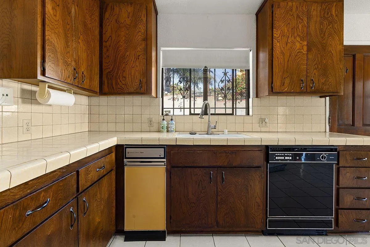 3344 Goldfinch Street San Diego, CA 92103 - Photo 17 of 41 a kitchen with stainless steel appliances granite countertop wooden cabinets and a sink