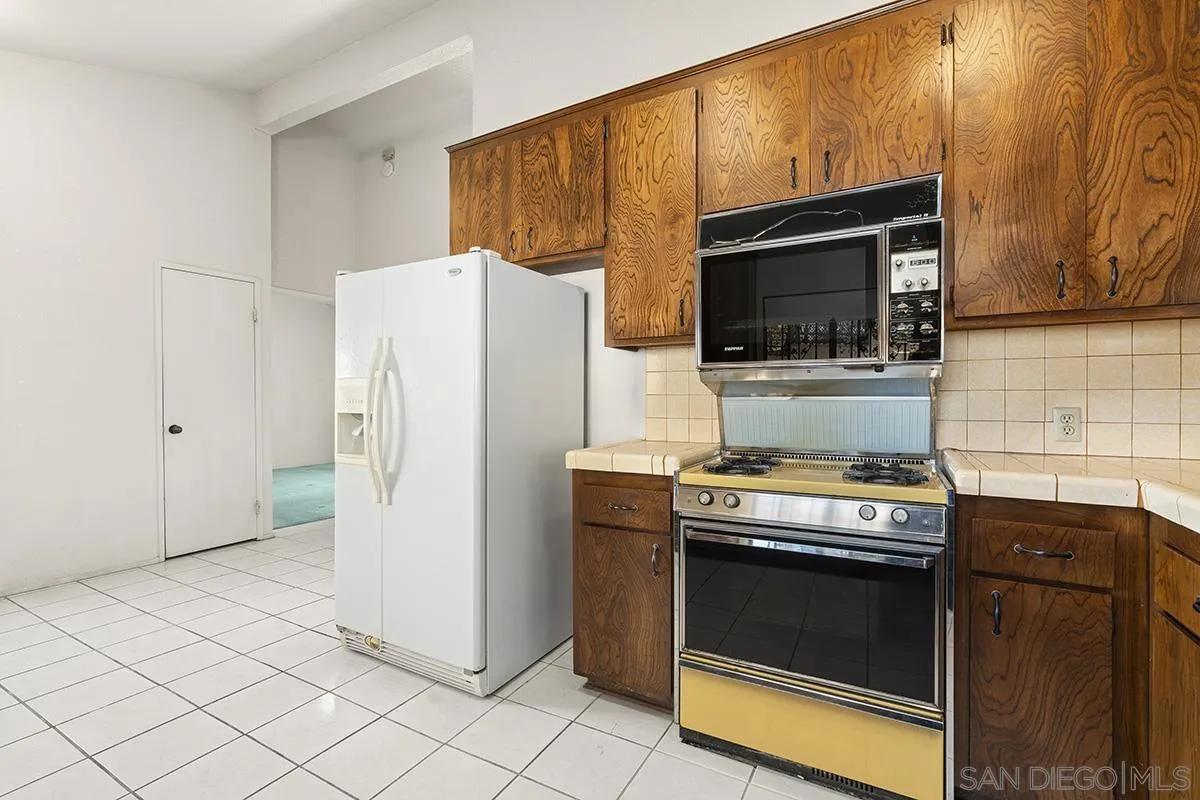 3344 Goldfinch Street San Diego, CA 92103 - Photo 19 of 41 a kitchen with a stove and a refrigerator