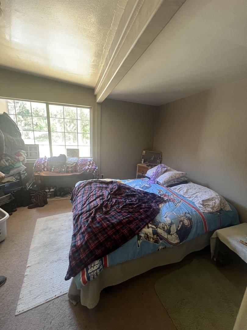 17160 Wilson Way Watsonville, CA 95076 - Photo 52 of 62 a bedroom with a bed next to a large window