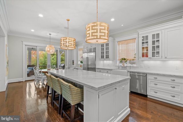 a view of entryway with wooden floor and front door