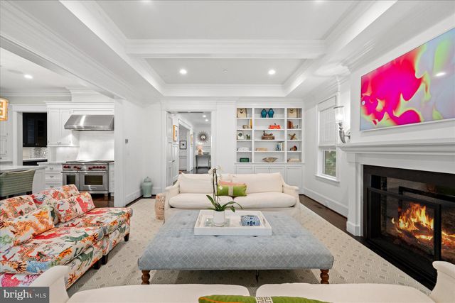 a bedroom with a large bed and large windows