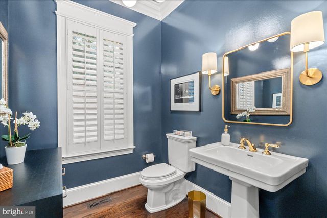 a bathroom with a granite countertop sink a toilet and shower