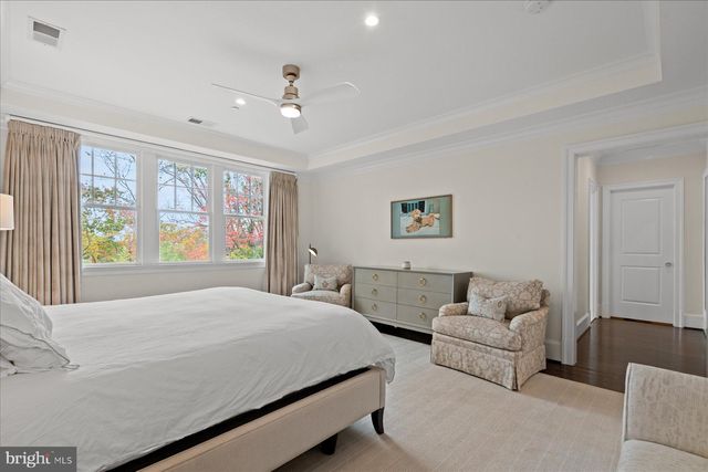 a bedroom with a bed and a lamp on dresser