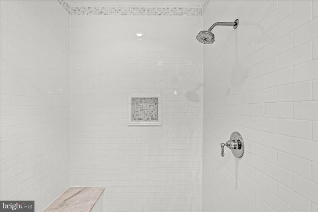 a view of staircase with white walls and a window