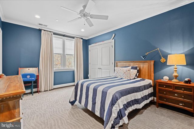a living room with furniture a flat screen tv and a floor to ceiling window