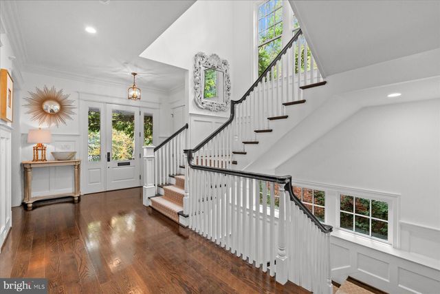 a living room with furniture a fireplace and a large window