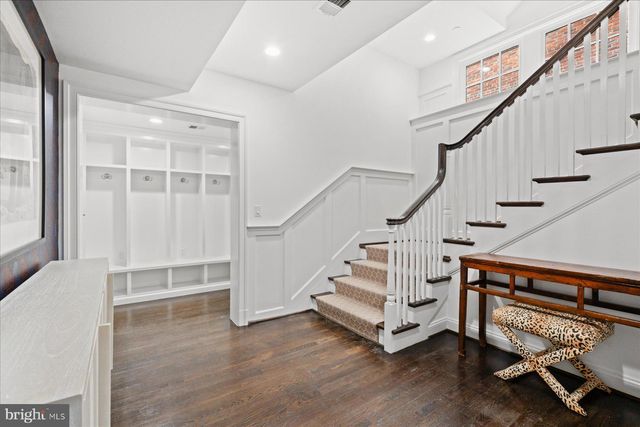 a view of a brick house with a bench in front of it
