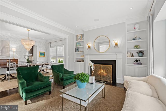 a dining room with furniture a chandelier and wooden floor
