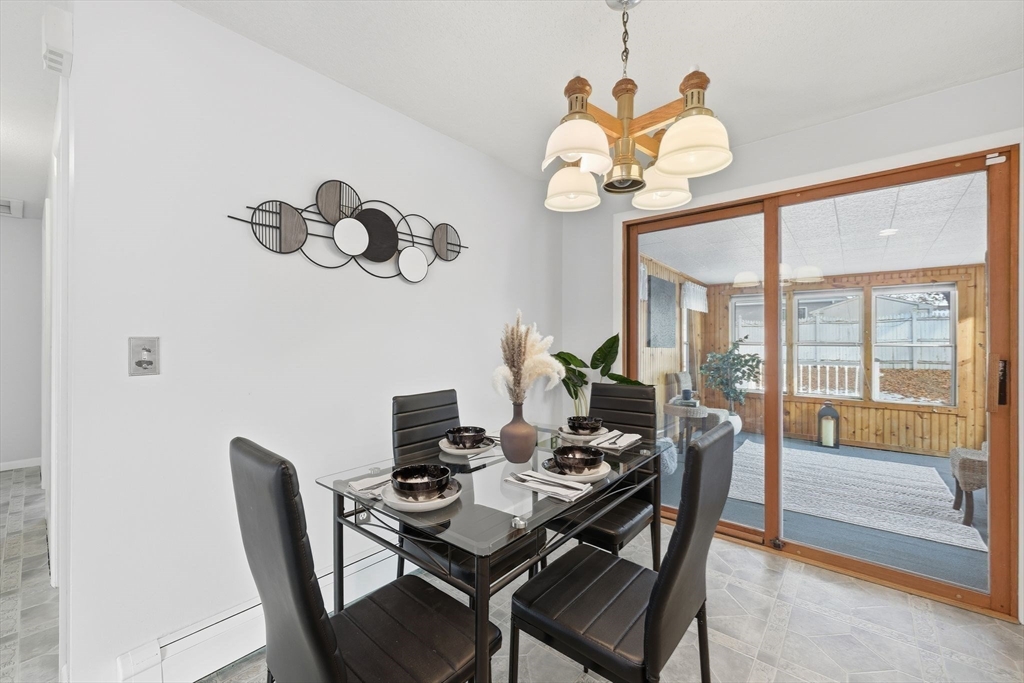 176 Silvin Road Chicopee, MA 01013 - Photo 11 of 32 a view of a dining room with furniture a chandelier and wooden floor