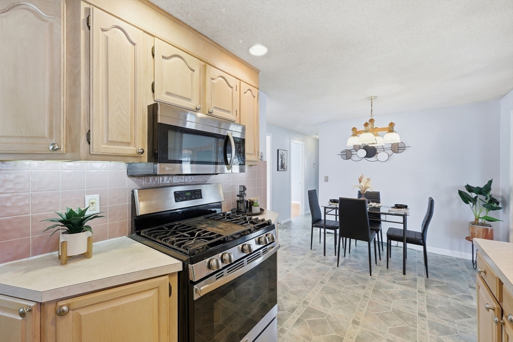 176 Silvin Road Chicopee, MA 01013 - Photo 13 of 32 a kitchen that has a stove and a white cabinets