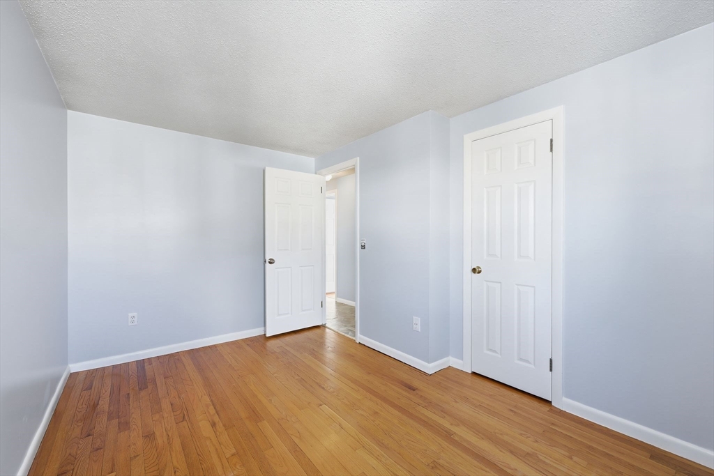 176 Silvin Road Chicopee, MA 01013 - Photo 19 of 32 a view of an empty room with wooden floor