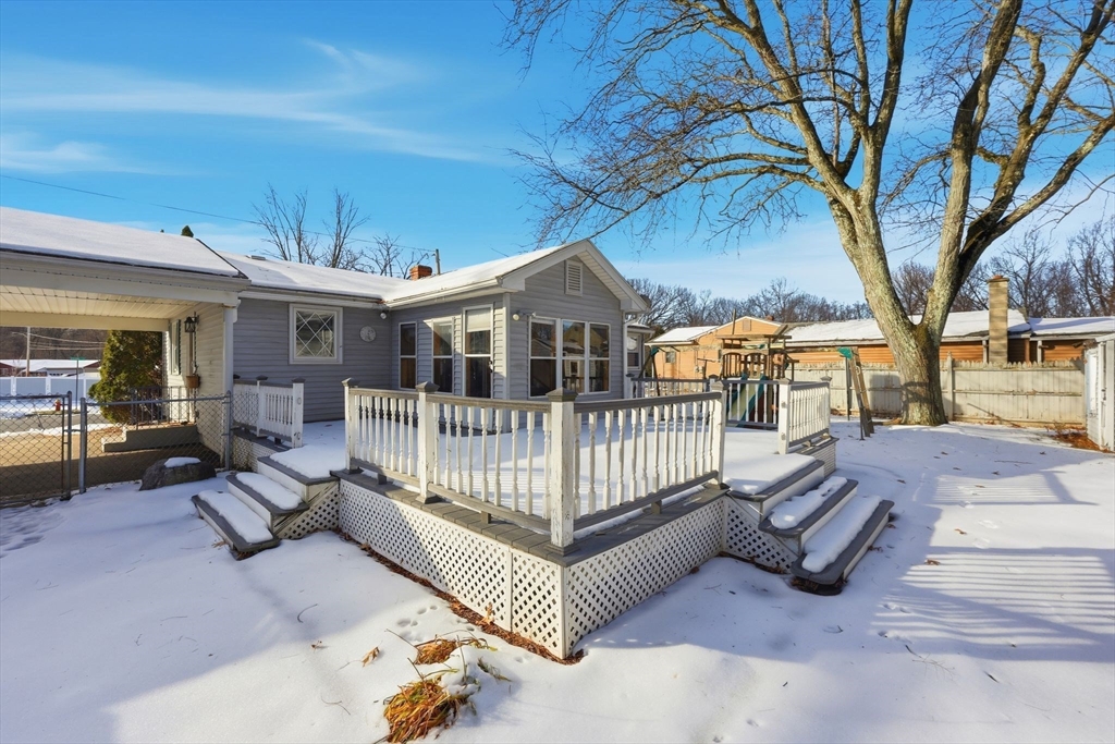 176 Silvin Road Chicopee, MA 01013 - Photo 29 of 32 a view of a house with a wooden deck and a backyard