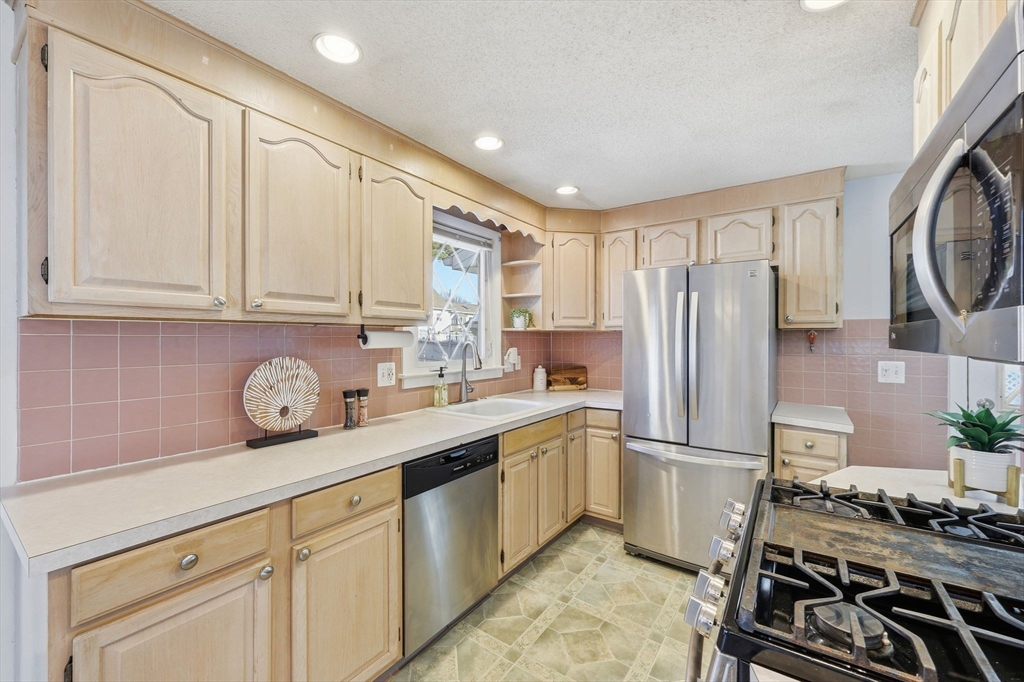 176 Silvin Road Chicopee, MA 01013 - Photo 6 of 32 a kitchen with stainless steel appliances granite countertop a sink stove and refrigerator