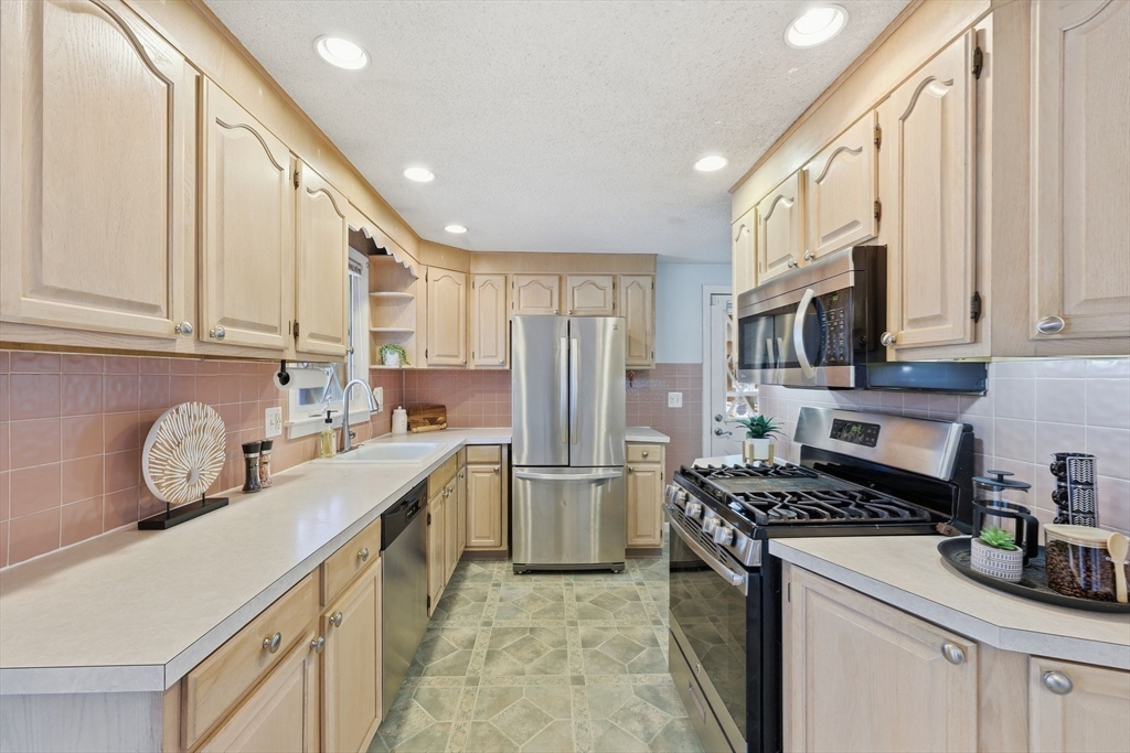 176 Silvin Road Chicopee, MA 01013 - Photo 9 of 32 a kitchen with stainless steel appliances granite countertop a stove a sink dishwasher a refrigerator and a microwave
