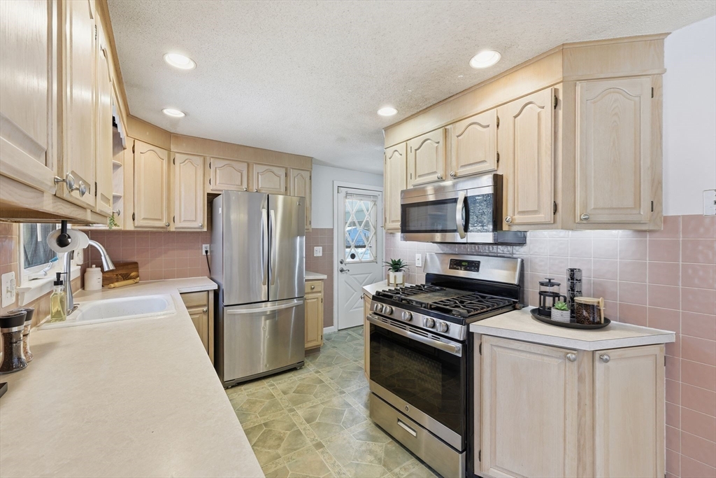 176 Silvin Road Chicopee, MA 01013 - Photo 10 of 32 a kitchen with stainless steel appliances granite countertop a refrigerator stove microwave and sink