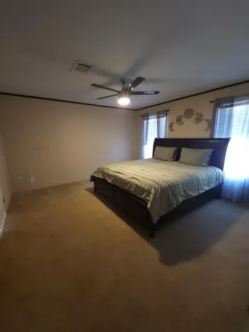 a large kitchen with stainless steel appliances a large counter top