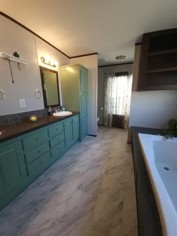 a bedroom with a bed and a mirror