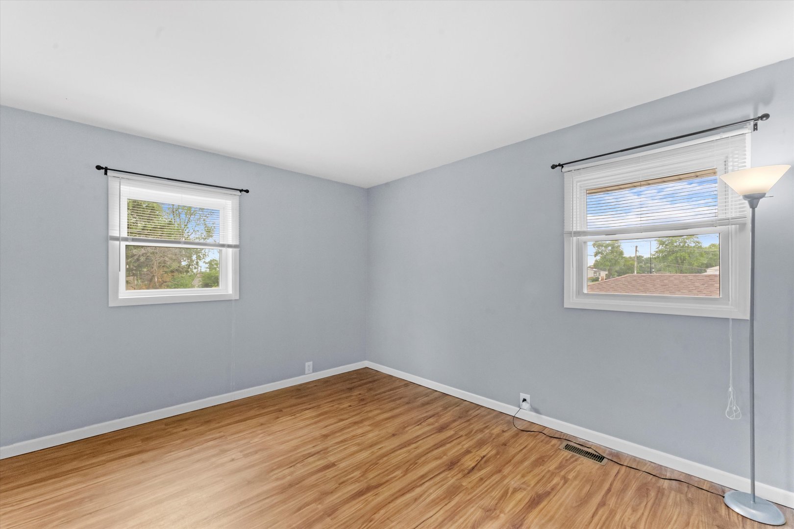 300 Hemlock Avenue Romeoville, IL 60446 - Photo 11 of 31 a view of an empty room with wooden floor and a window