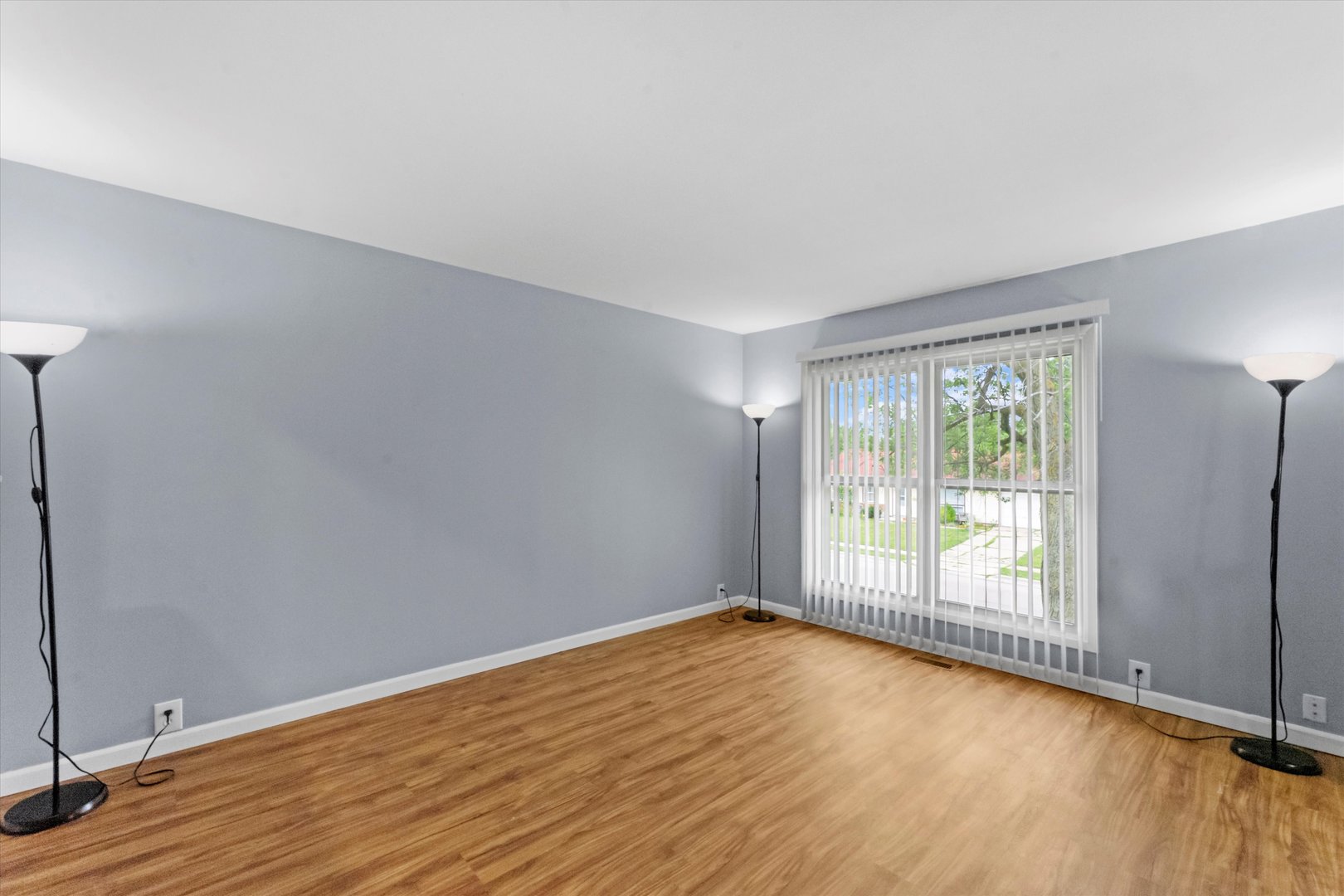 300 Hemlock Avenue Romeoville, IL 60446 - Photo 3 of 31 an empty room with wooden floor and windows