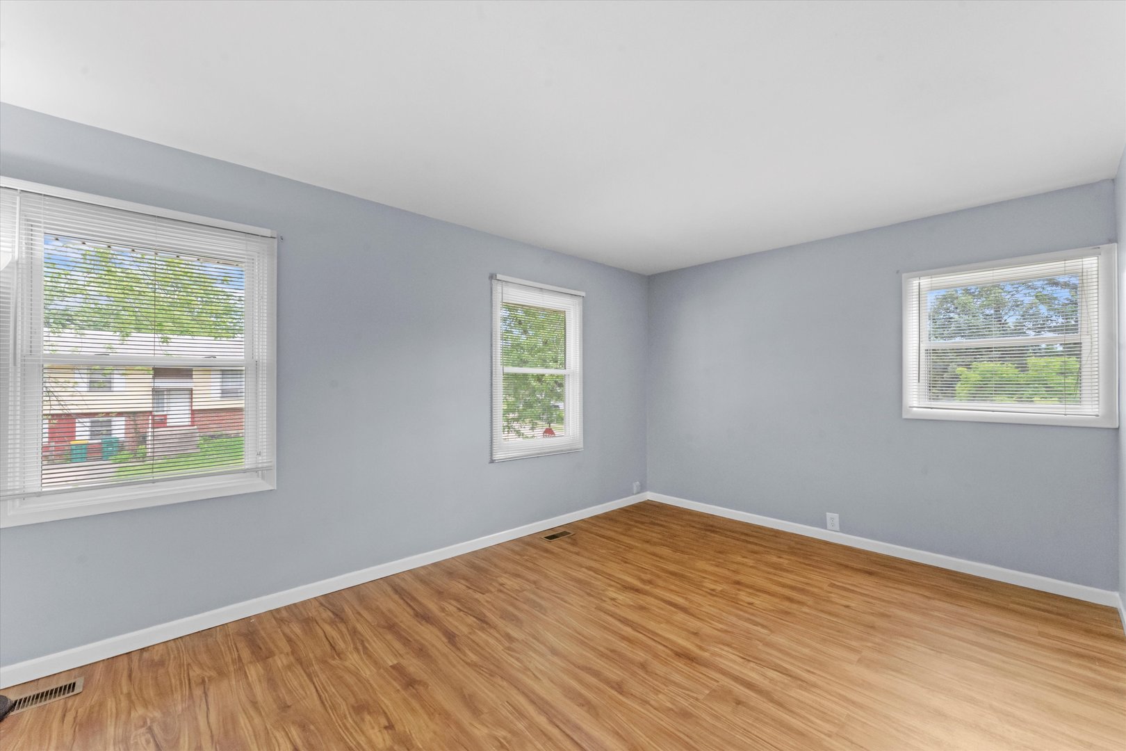 300 Hemlock Avenue Romeoville, IL 60446 - Photo 5 of 31 a view of an empty room with wooden floor and a window