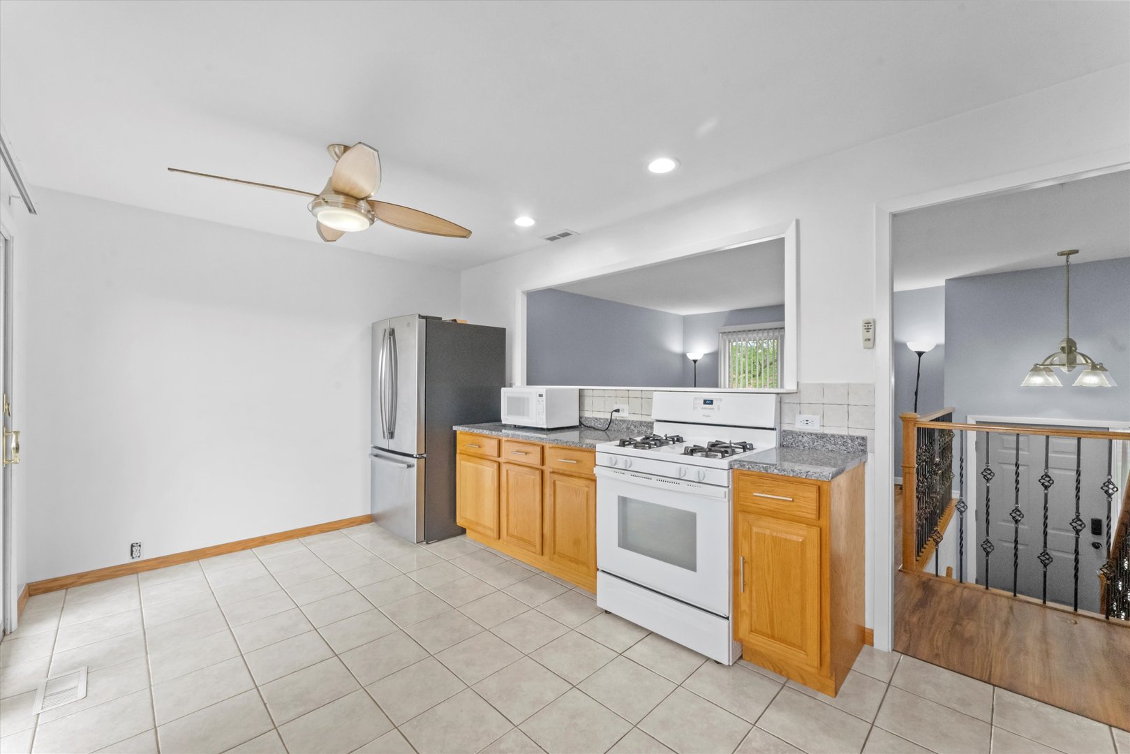 300 Hemlock Avenue Romeoville, IL 60446 - Photo 6 of 31 a kitchen with stainless steel appliances granite countertop a refrigerator and a stove top oven