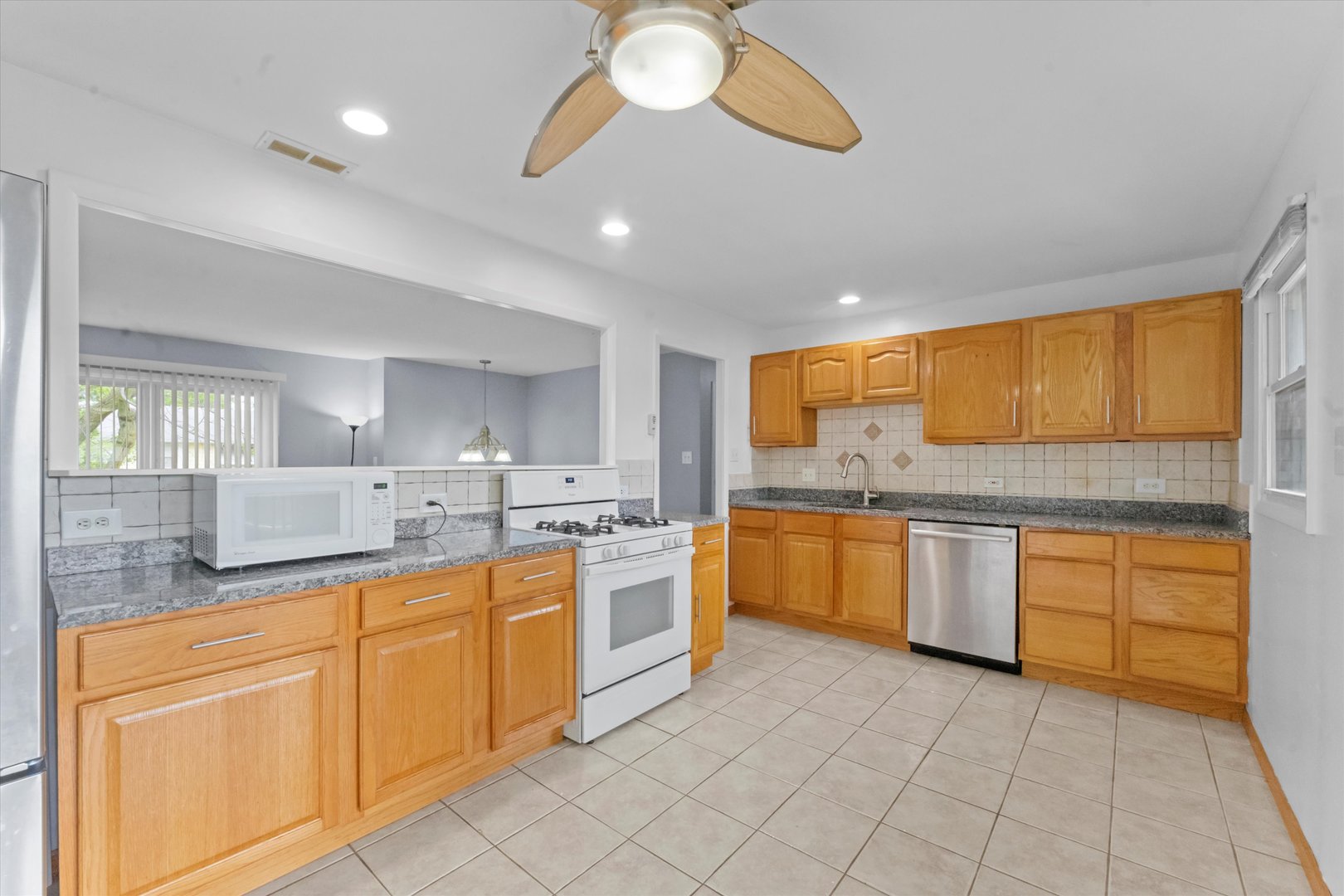 300 Hemlock Avenue Romeoville, IL 60446 - Photo 7 of 31 a large kitchen with stainless steel appliances granite countertop a sink and cabinets