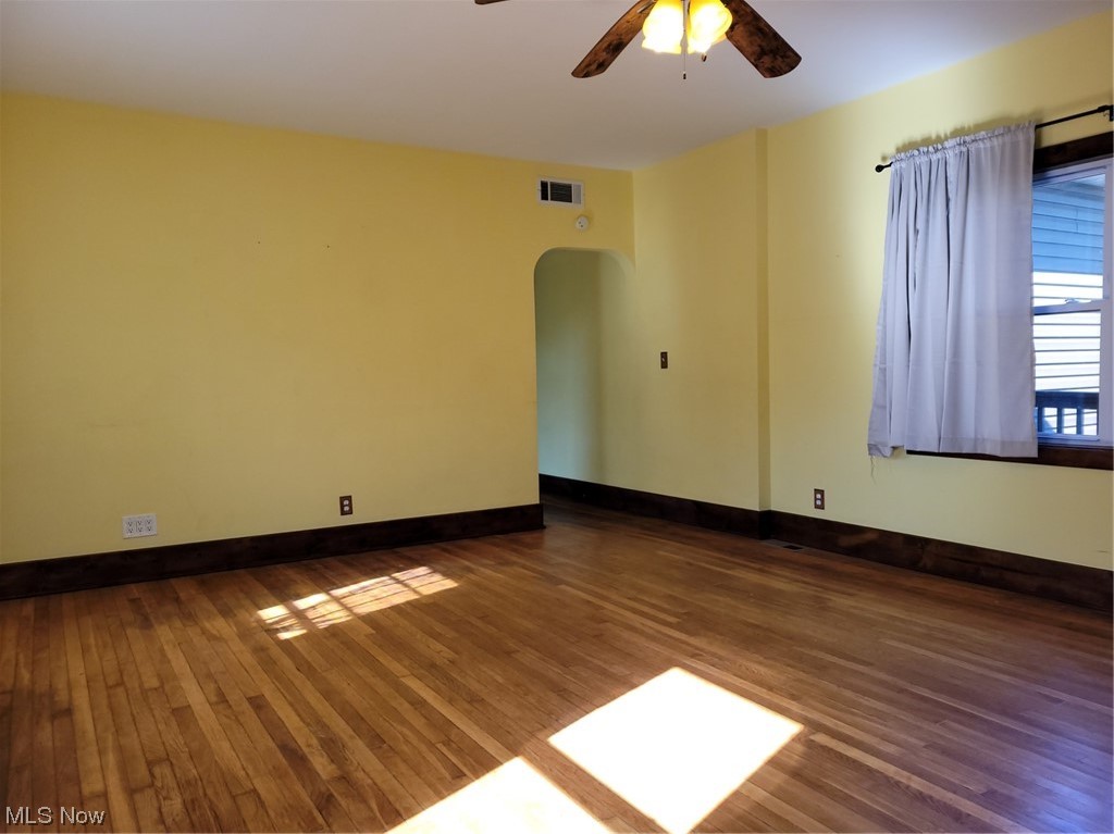 22922 Putney Ridge Road Quaker City, OH 43773 - Photo 19 of 31 Empty room featuring ceiling fan, hardwood flooring, and a skylight