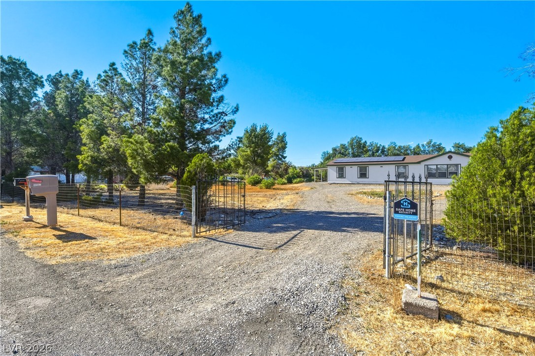 1890 West Dyer Road Pahrump, NV 89048 - Photo 13 of 40 This expansive property features a well-maintained exterior with a secure gated entrance.