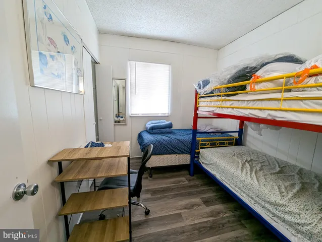 a bedroom with furniture and a wooden floor