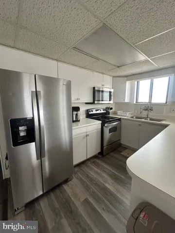 a kitchen with stainless steel appliances granite countertop a stove a sink dishwasher a refrigerator and a microwave