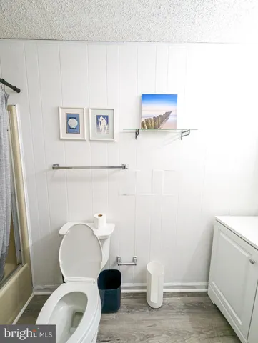 a white toilet sitting next to a bathroom sink