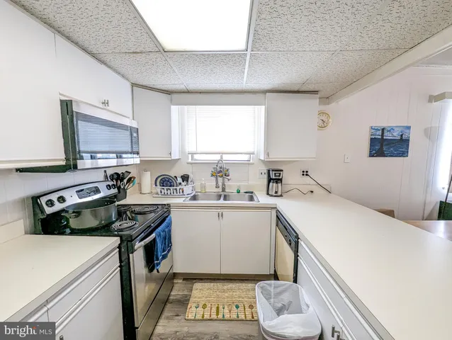 a kitchen that has a sink and a stove in it