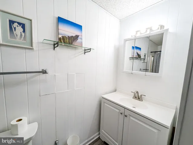 a bathroom with a sink a mirror and a toilet