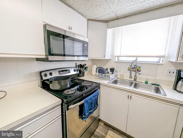 a kitchen with a stove a sink and a microwave