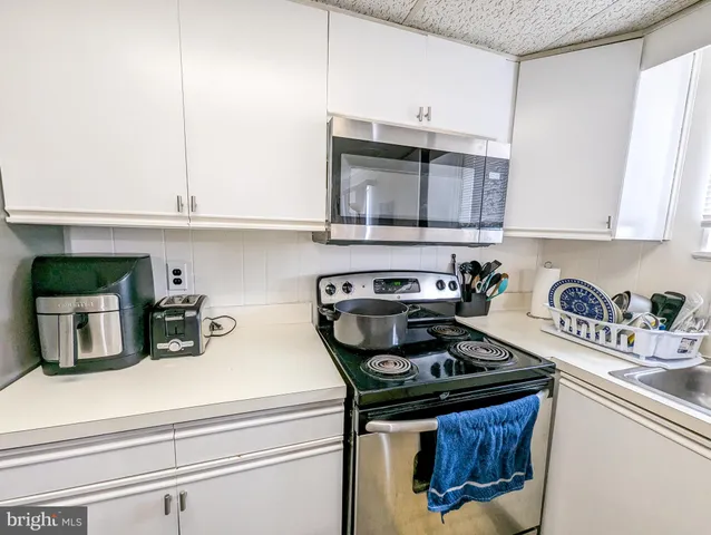 a kitchen with a stove and cabinets