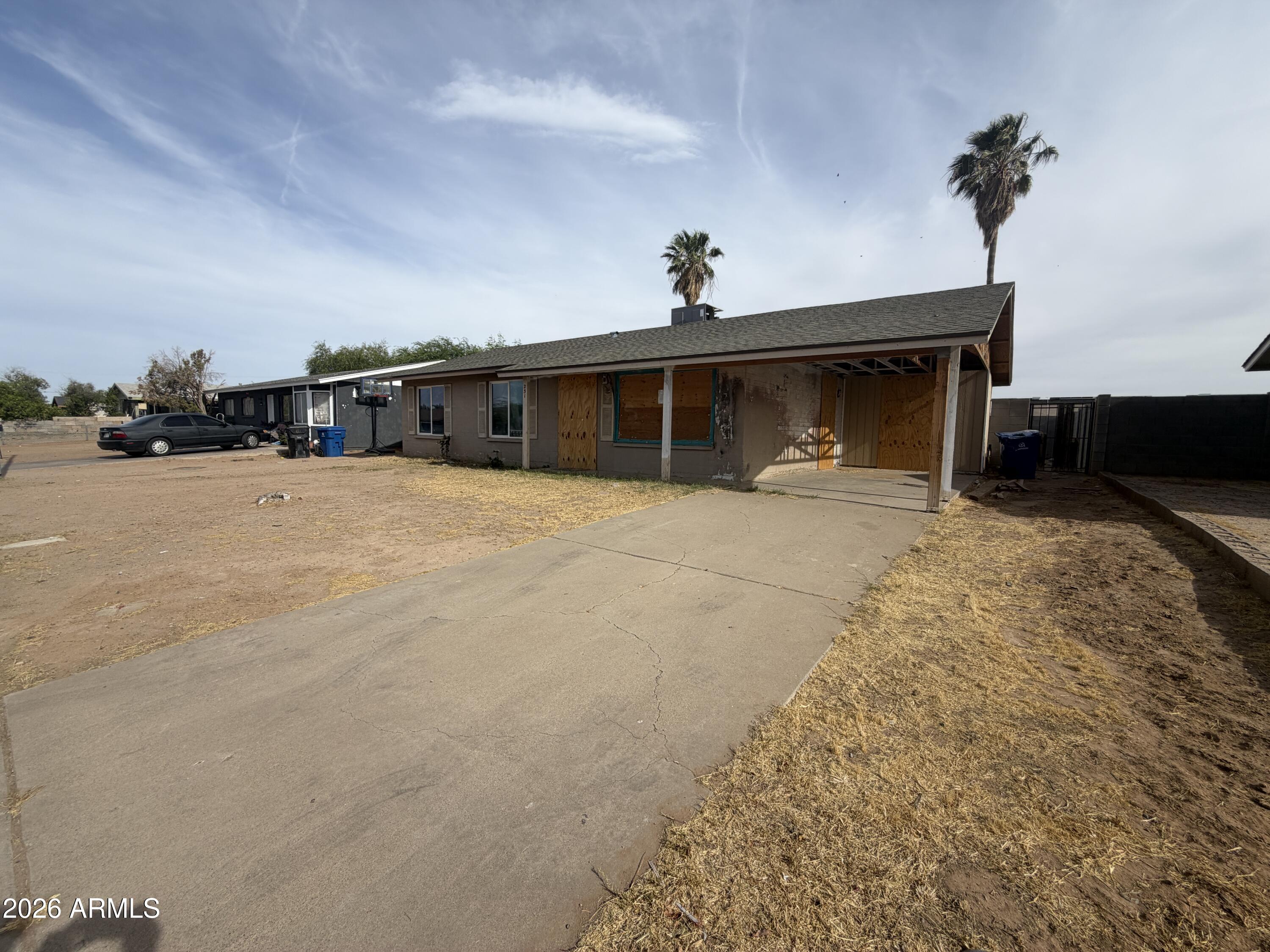 231 West Rhodes Avenue Avondale, AZ 85323 - Photo 2 of 7 a view of a house with a snow in the yard