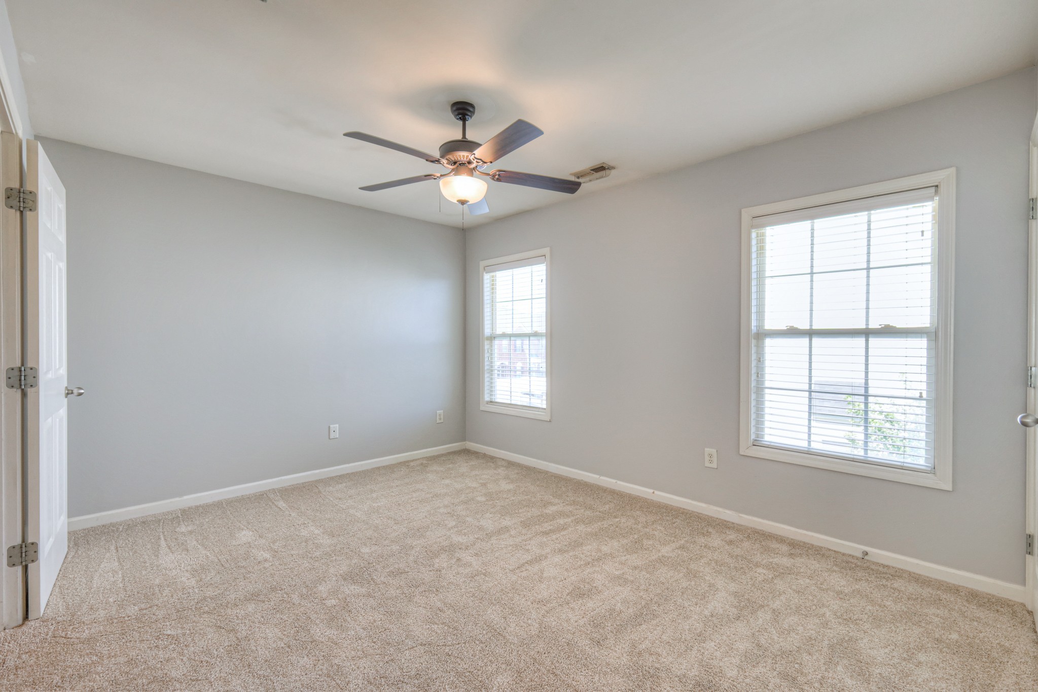 4027 Clinton Lane Spring Hill, TN 37174 - Photo 16 of 25 an empty room with chandelier fan and windows
